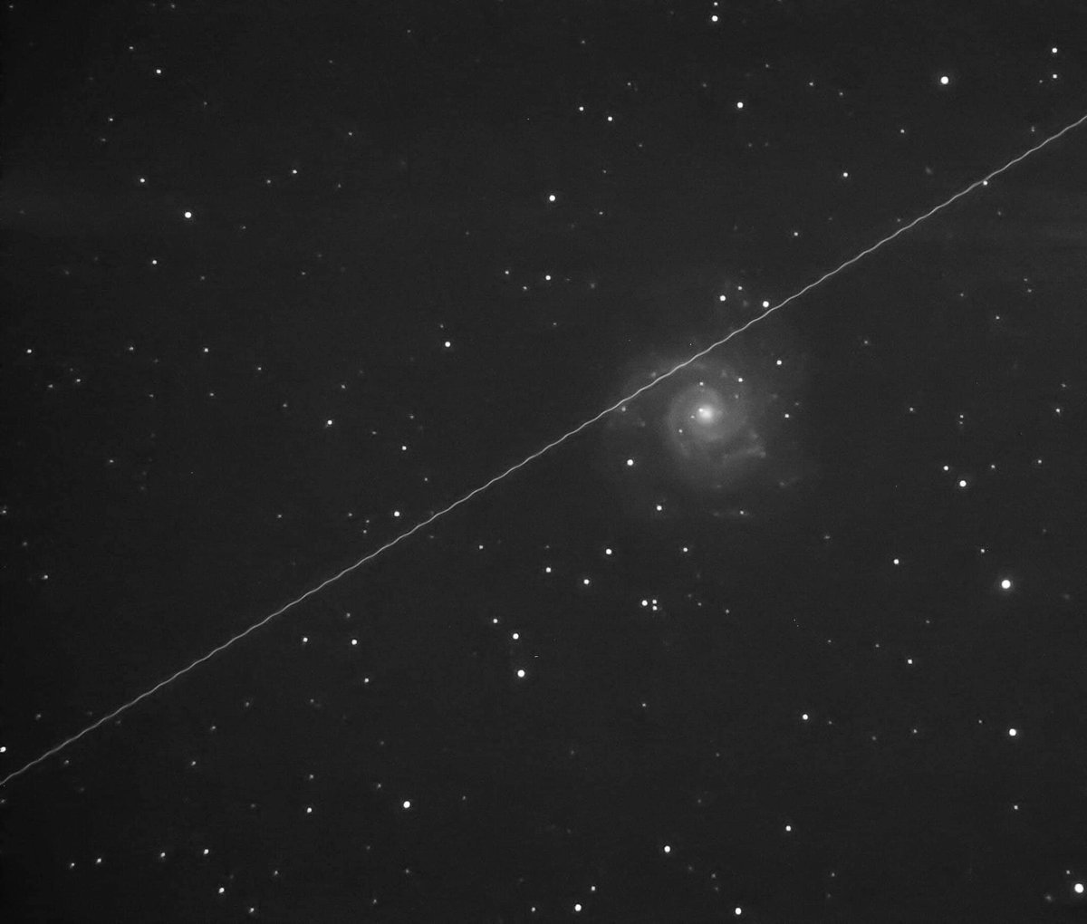 Unprocessed Phantom galaxy image. Note the path of the sattalite... and the wavy pattern from its rotation as it transits the frame.