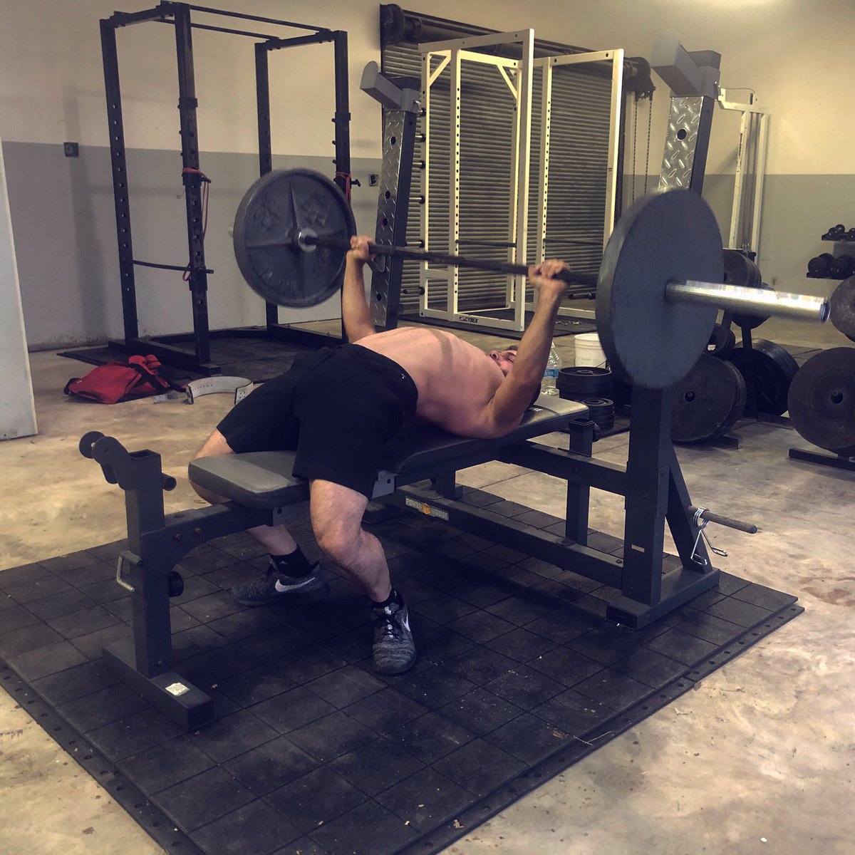 The goal is to get your shoulders down and back  and your chest up So that the weight and pressure is taken off your front delt, rotator cuff and the shoulder joint in general.Benching is notorious for causing bad shoulders.. it shouldn’t be if done correctly.