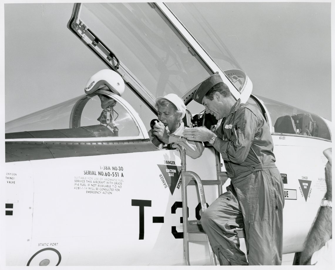 Perhaps one of my favourites: Jackie touching up her lipstick while Chuck gives her some last-minute instructions in the T-38.