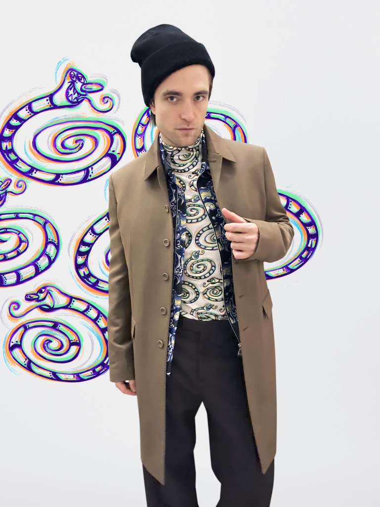 Dior's tweet photo. Longtime House friend Robert Pattinson caught the #DiorMenFall 2021 https://t.co/f2Hg2D8KVu show from Kim Jones from the comfort of home in a brown wool coat and oversize pants with 'Dior and Kenny Scharf' print blouson and mockneck sweater from the collection.
#StarsinDior https://t.co/LIbGmK7jBP