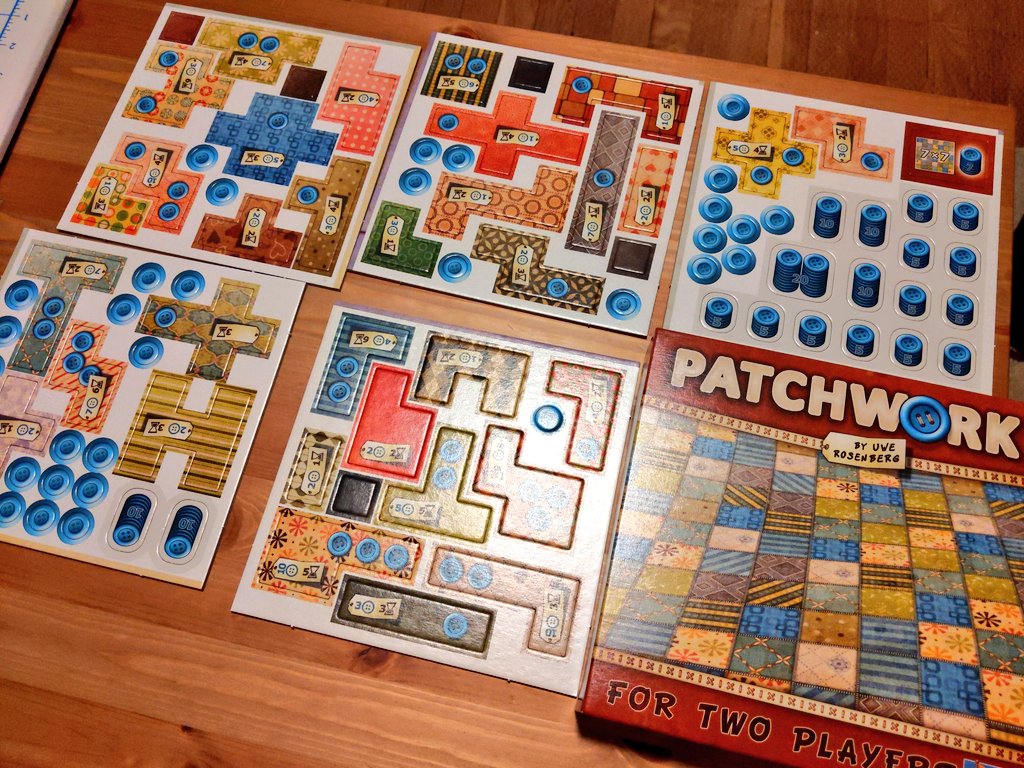 Cardboard bits are manufactured with basically giant fancy paper punches. They use dies, which are sheet sized blades that cut the pieces out. These used to have to made by hand, but not also so now. They're still time consuming to make and test. Think cookie cutter for cardboard