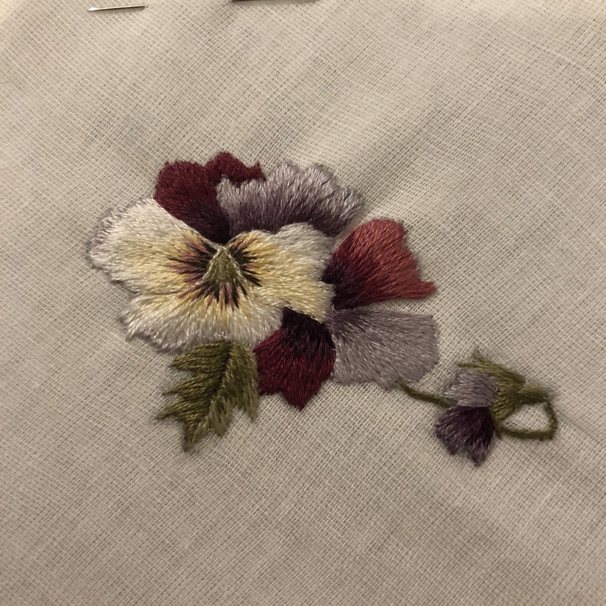 Colours don’t really show on account of it being permanently dark right now but I stitched a pansy and it looks reasonably pansy like. #needlework #embroidery #needlepainting