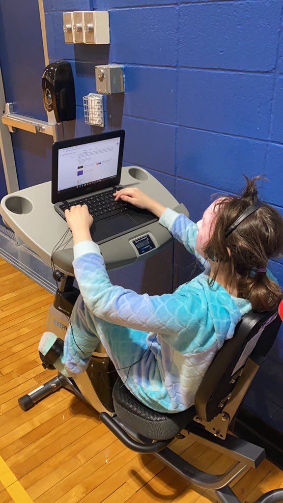 WSDCoachHeidorn's tweet photo. Girlfriend working hard both mentally and physically today! She is getting caught up on her virtual assignments while breaking a sweat! 💦 🧠 💪🏼 🚴
#2020MiniGrant #BikeDesk #BestAtWMS @wmspe1 https://t.co/U1cysaLRtR