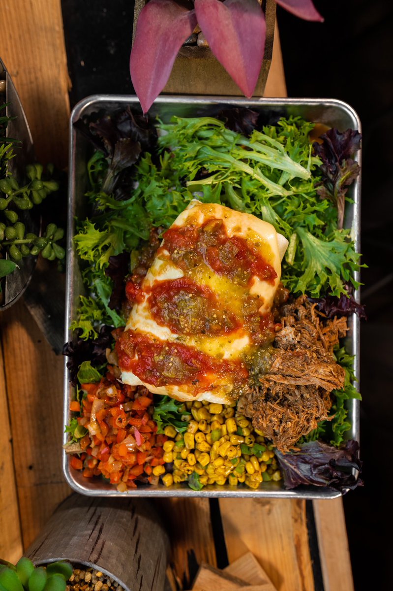 Weekly special! Smothered Barbacoa Burrito! Slow roasted and barbacoa marinated pulled pork, cilantro lime rice, pinto beans, sautéed peppers and onions, corn salsa, and jalapeños wrapped up on a warm flour tortilla and smothered in house-made queso and topped with salsa!