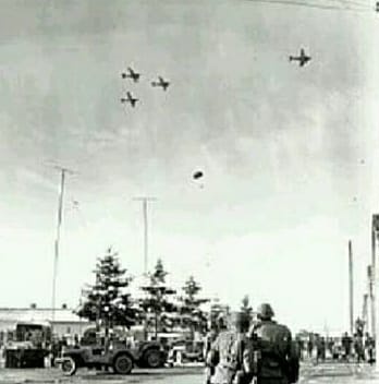 Within 30 minutes of the Pathfinders landing, the planes were almost over Bastogne, "As we neared Bastogne we could see snow everywhere. We removed the door as we prepared to push the parabundles out over the DZ. I could see German half-tracks with 88mm guns."17/