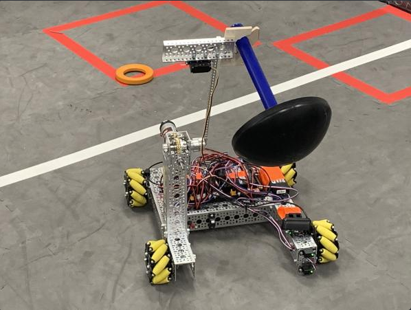 Installed an arm attachment to pick up the wobble goal in both autonomous and endgame. It opens and closes to pick the wobble goal up and can move itself up and down.