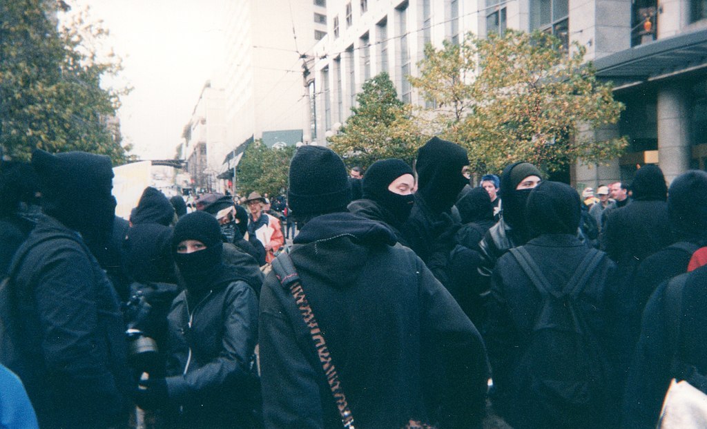 27) However, the protests were marred by a group known as the black bloc, which Mark M. Rich defines as “a collection of affinity groups that assemble during anti-globalization and anti-corporate protests…”