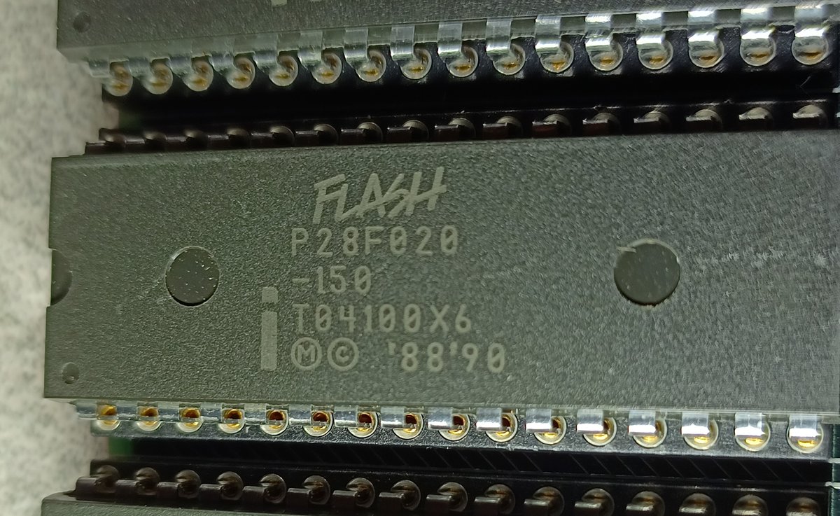 And next to that, there's these chips, which are Intel P28F020-150 Flash chips.Those are 256 kilobytes each, and there's 8 of them... so we're at 2 megabytes again.