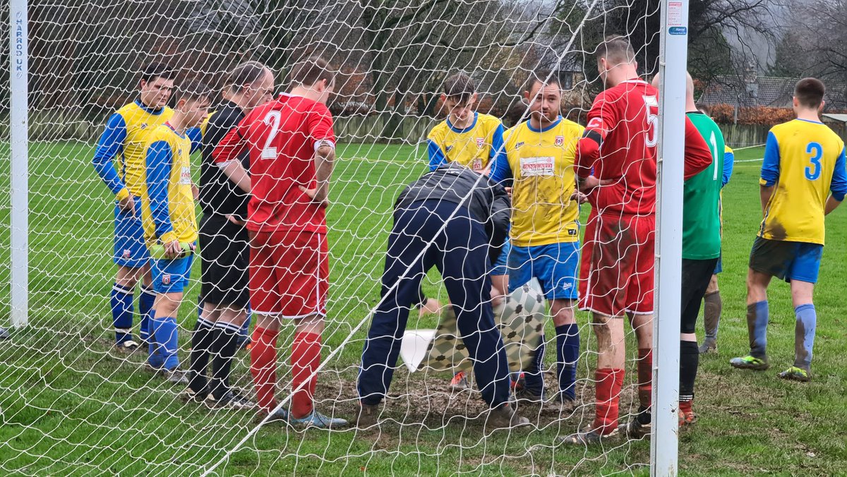 The Duncombe Park substitute, who had been linesman this half, returned with a rolled up offcut of kitchen lino. With a 'abstract' design, it was placed face down in the penalty area over the tree root.