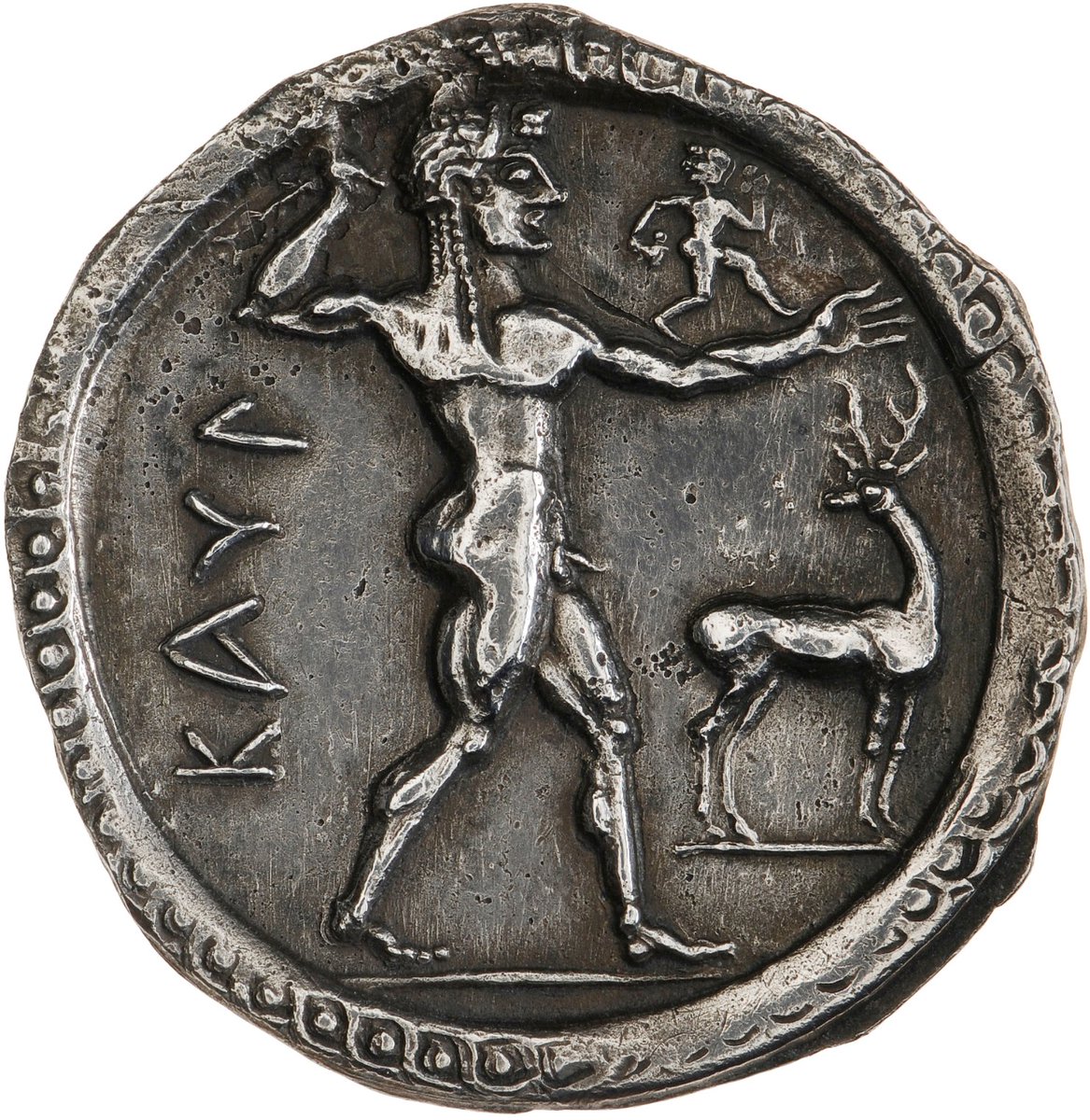 The Obverse of this stater shows a nude Apollo, carrying a branch (perhaps of laurel), with a small running figure on his outstretched left arm. The pose of the figure, with one leg advanced, evokes the Kouros type statues of the period, although the pose is more animated.
