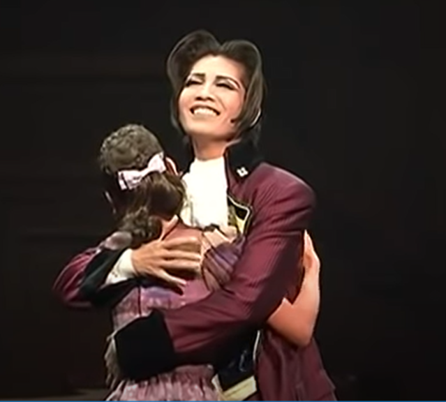 almost done I swear. So the romance angle is so weird. And the way they portray Miles in it I can't even really believe. Do you mean to tell me Miles would EVER look like this hugging anyone, much less a woman? Am I supposed to believe that, musicals?