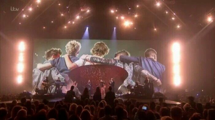 yourebestever's tweet image. While they were singing History, a snapshot of the band over the years were shown on a screen behind them 
#1DXFactor
#10YearsOfOneDirection 
#10YearsOf1D