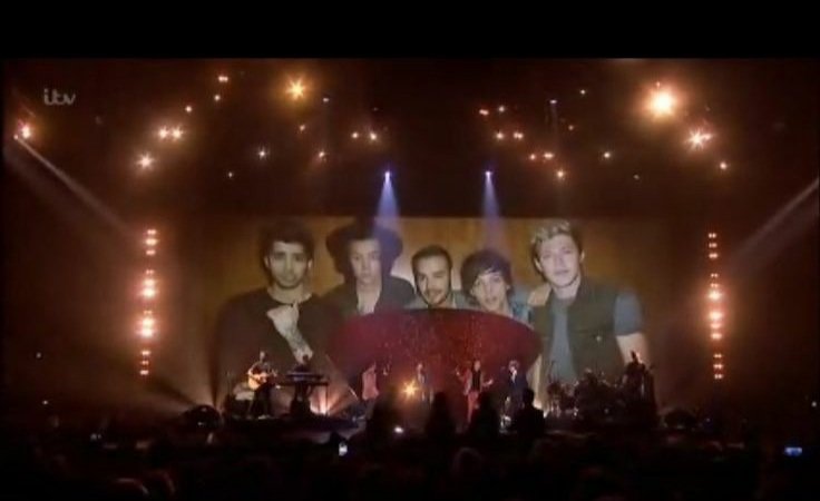 yourebestever's tweet image. While they were singing History, a snapshot of the band over the years were shown on a screen behind them 
#1DXFactor
#10YearsOfOneDirection 
#10YearsOf1D