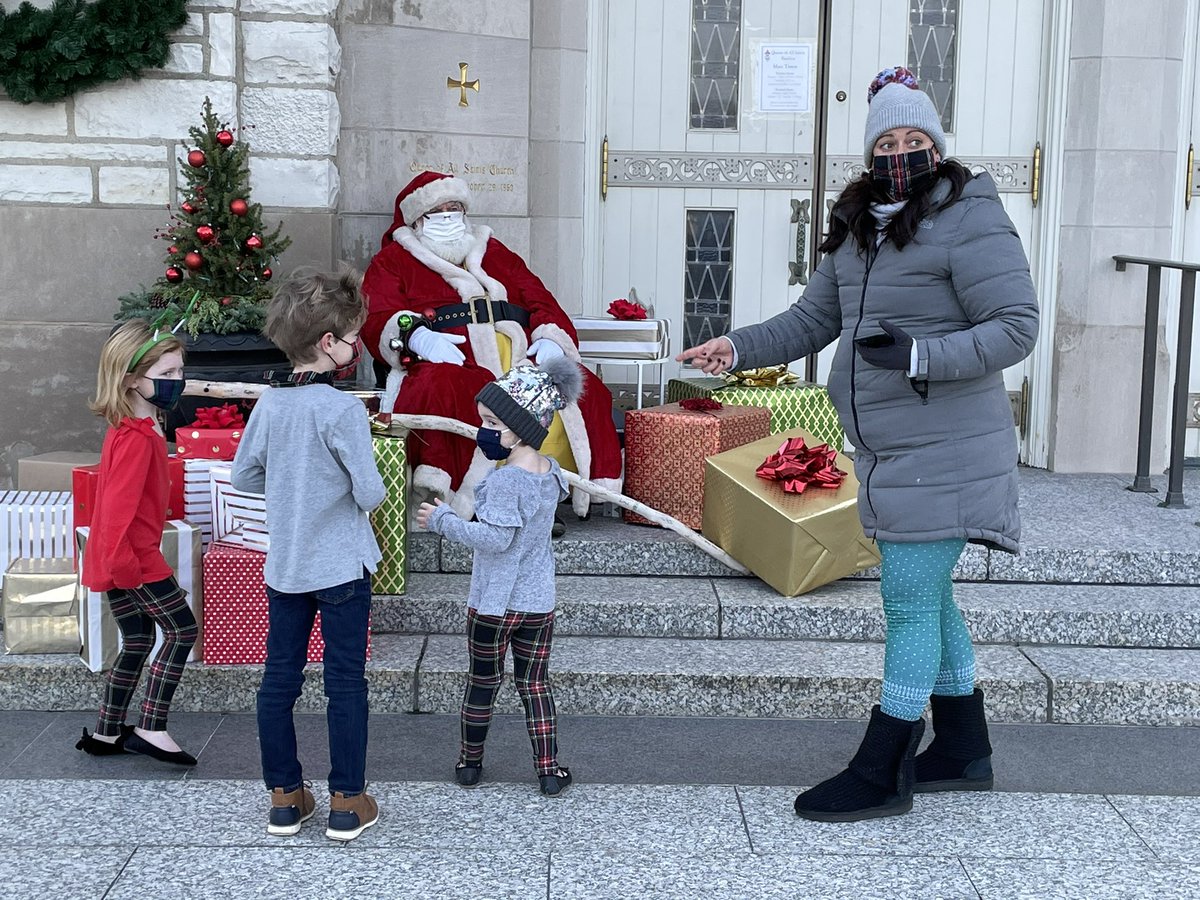 chicagocatholic's tweet photo. Queen of All Saints Basilica Parish and School is hosting a drive thru toy drop off and socially distanced photos with Santa today. Toys will be donated to @CCofChicago Seventh and eighth graders are retrieving the donations from cars. https://t.co/jd4TfUvjW5