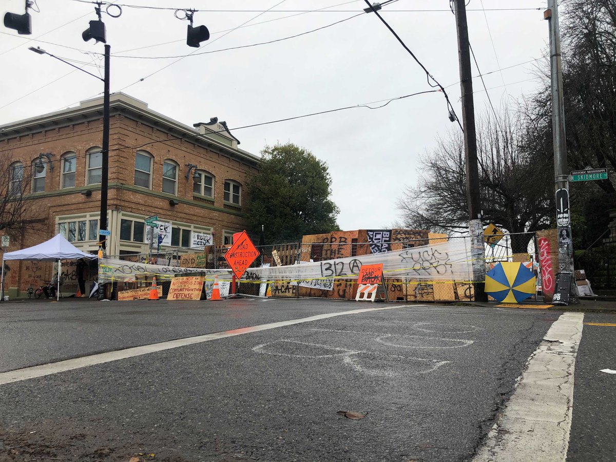 I revisited Red House today after news broke of a deal negotiated between the city and the Kinney family. By noon, 100+ people were taking down barricades that had blocked North Mississippi Avenue for six days. Here's a before/after view of Skidmore Street: