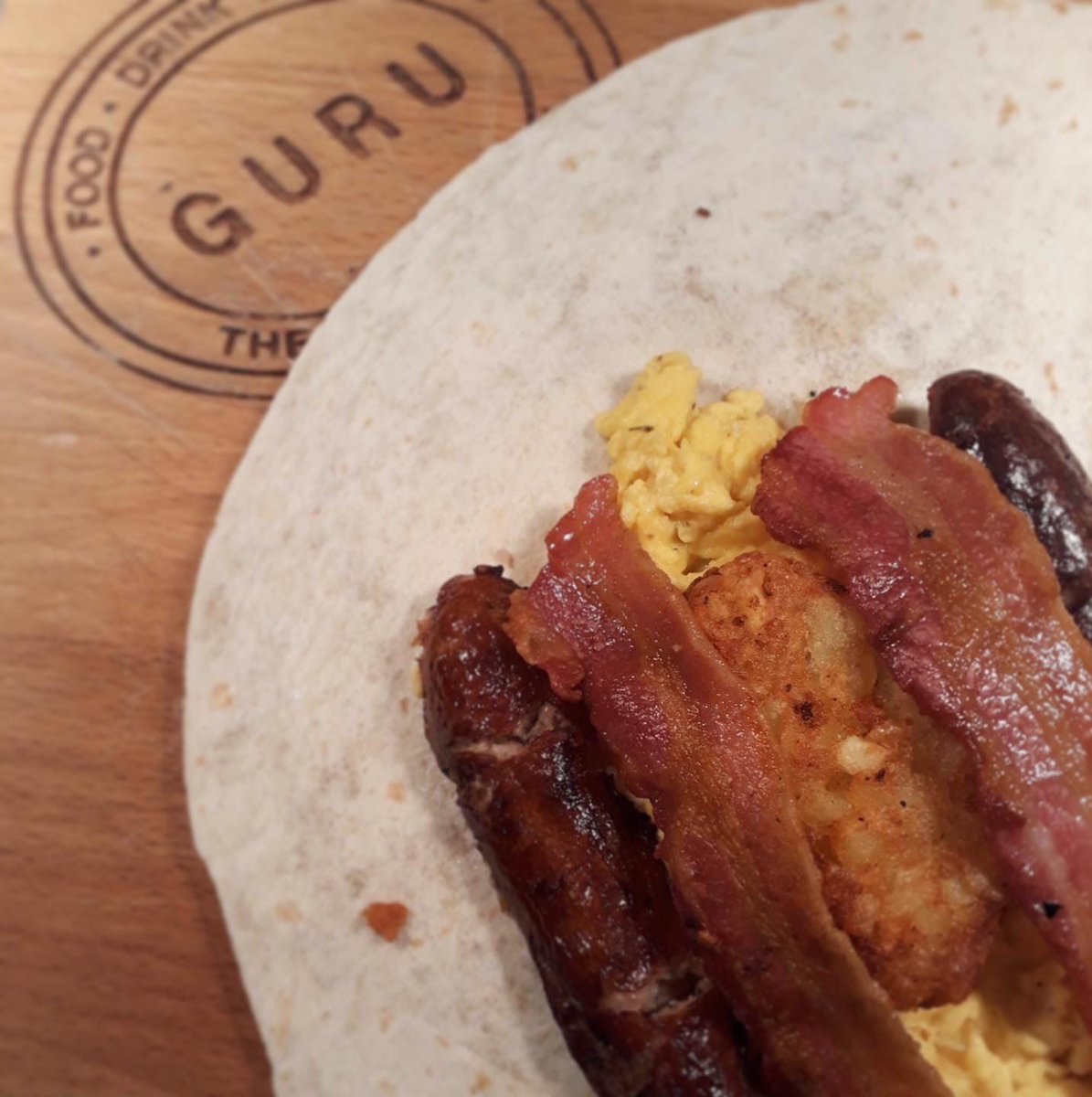 On the 2nd day of Christmas, Guru is giving to you...

Half Price Breakfast Wraps now only £2.50! 🎄

Delicious Gloucester sausage and bacon with a hash brown topped off with scrambled Coopers Hill eggs all wrapped up in a soft tortilla.

Order online or enjoy in our restaurant.