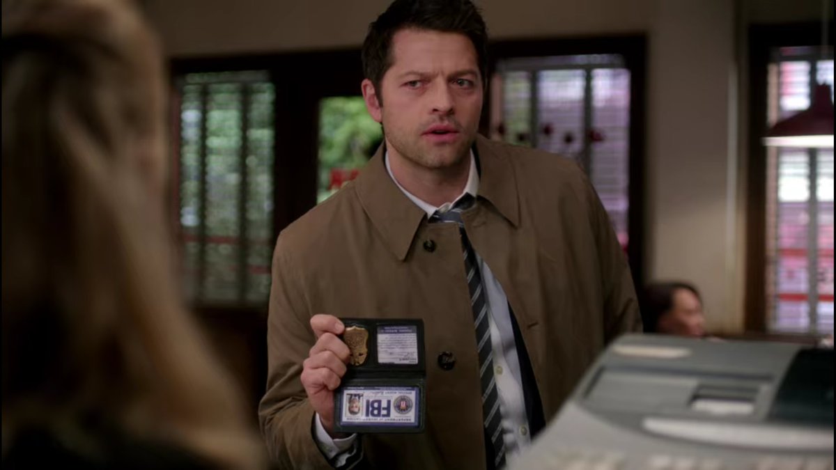 *holds badge upside down*