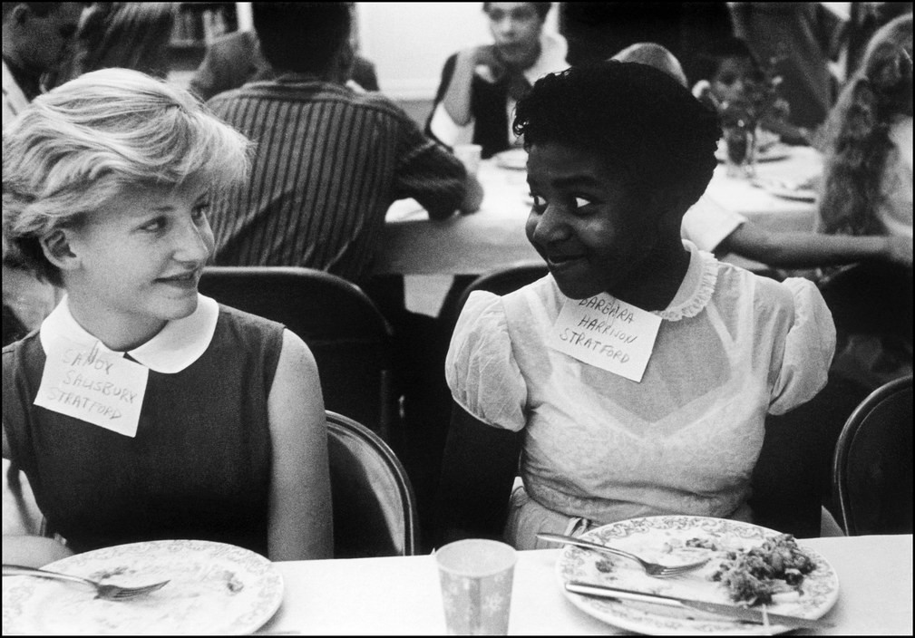 No one is born racist .Two girls sit next to one another at a party to introduce mixed schools, Virginia, USA, 1958. Photo Eve Arnold