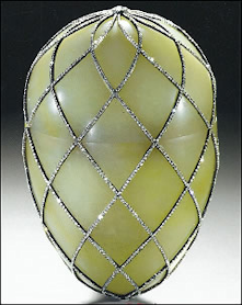 The egg is made of jadeite, gold, rose-cut diamonds, and is lined with white satin. It is carved from pale green jadeite and is enclosed in a lattice of rose-cut diamonds with gold mounts.