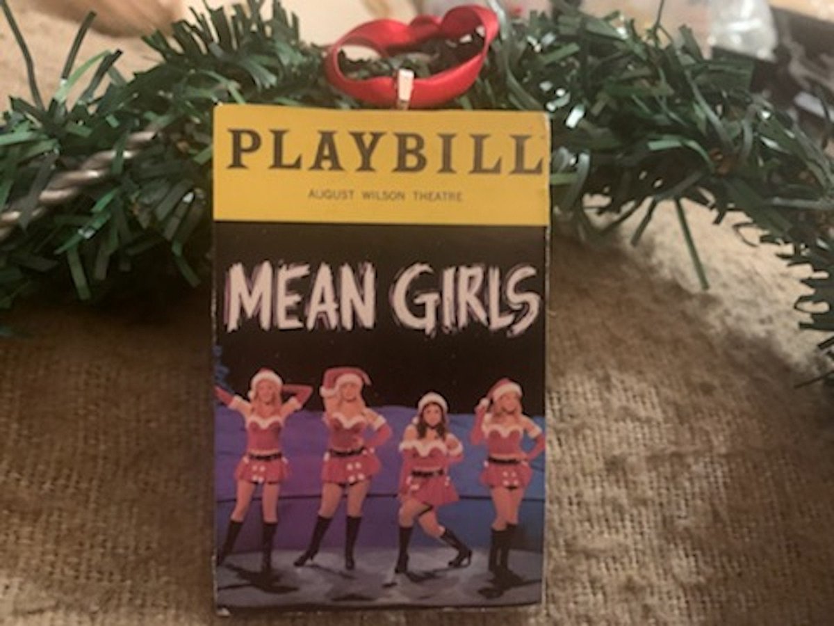 BroadwayBazaar's tweet photo. Mean Girls Christmas Edition Playbill Ornament https://t.co/h9ll8Ei8TZ #christmas #playbill #musicaltheater #broadway #ornament #openingnightgift #musicaltheatre #wood #broadwaybazaarstore https://t.co/rk6A3Frd6K