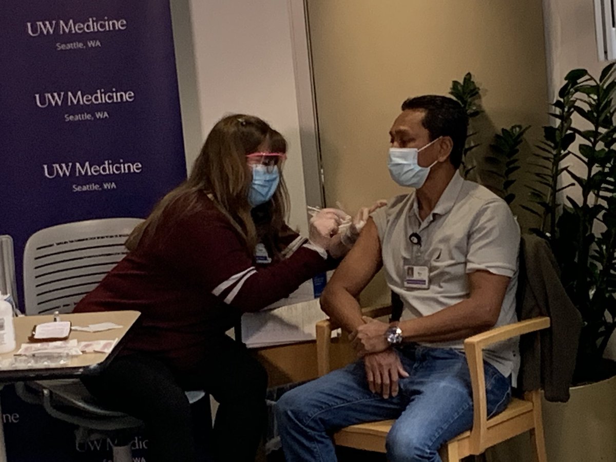 Patient Care Technician Myo Thant receives the vaccination.