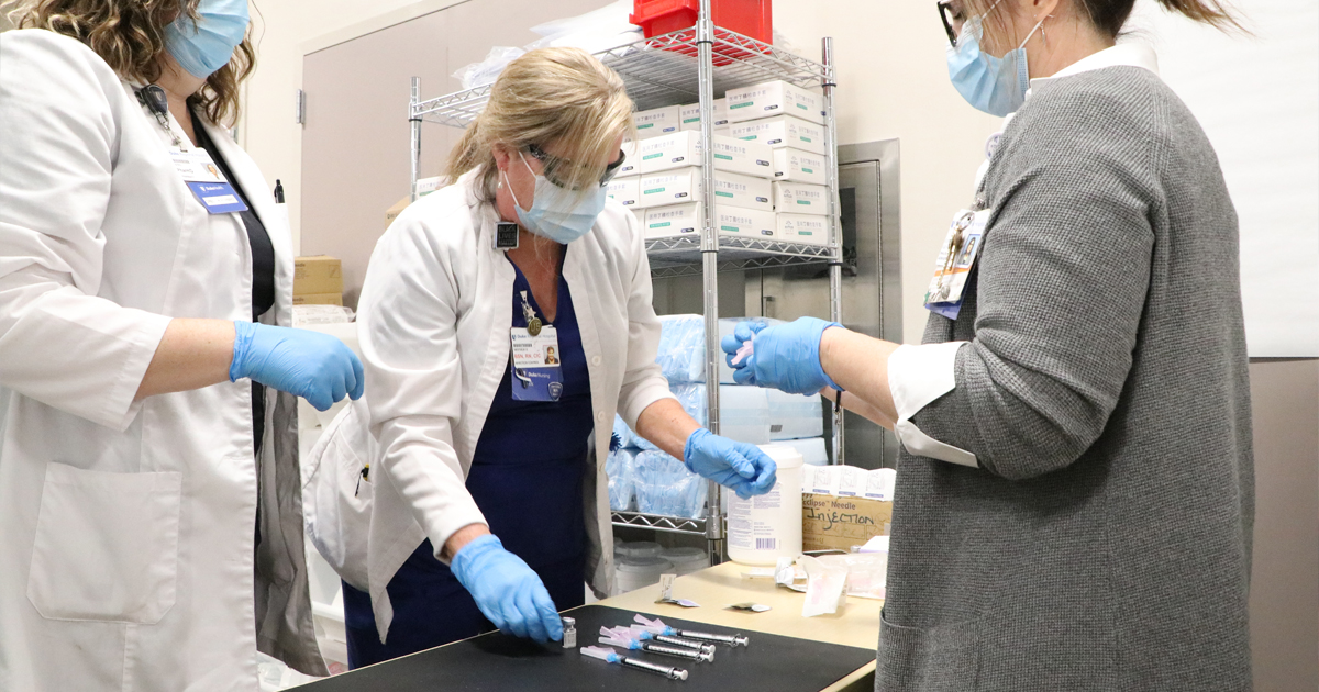 Frontline health care colleagues prepare COVID-19 vaccinations at Duke Regional Hospital.