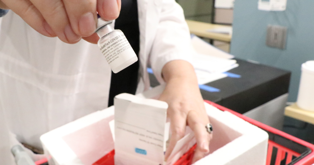 Unpacking COVID-19 vaccines at Duke Regional Hospital.