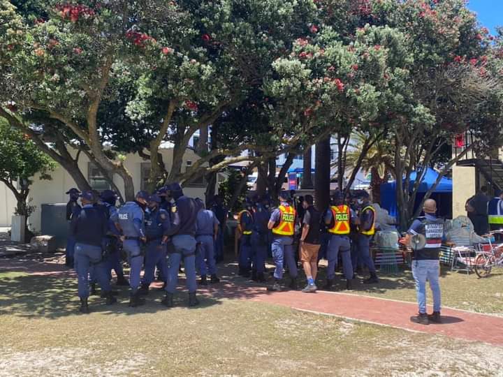 Mr <a href="/PresidencyZA/">The Presidency 🇿🇦</a> could you explain why the Minister Of Police needs over 30 SAPS members next to him enforcing COVID19 rules when a few km's away, innocent people are being killed by gang fighting and no often then not the excuse is a shortage of police officers? <a href="/Unathi_Kwaza/">Unathi</a>