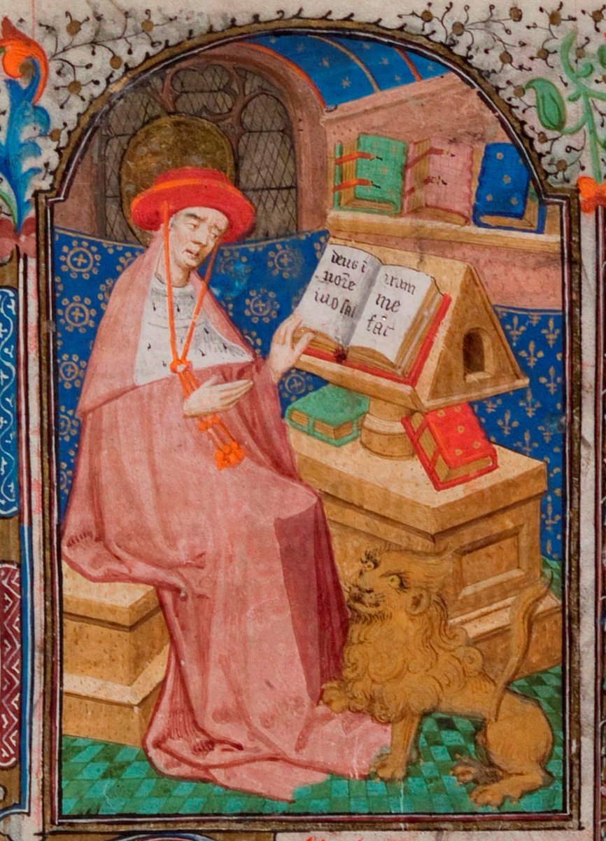Here St Jerome is shown as a cardinal sitting in front of a reading stand with books. A lion sits at his feet raising his paw, a nod to the legend of St Jerome removing a thorn from a lion’s paw.  #BookofHours