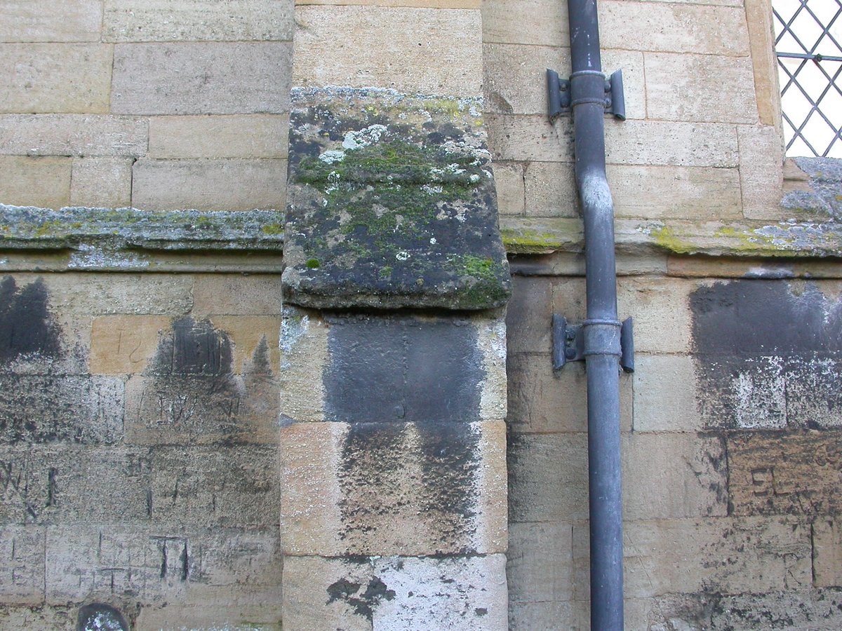 On the vertical stonework below the buttress slope is a sooty evaporite deposit, a legacy of decades of coal burning in the past. On the slightly mossy buttress slope above is more black crust, this time a lichen (Verrucaria nigrescens).