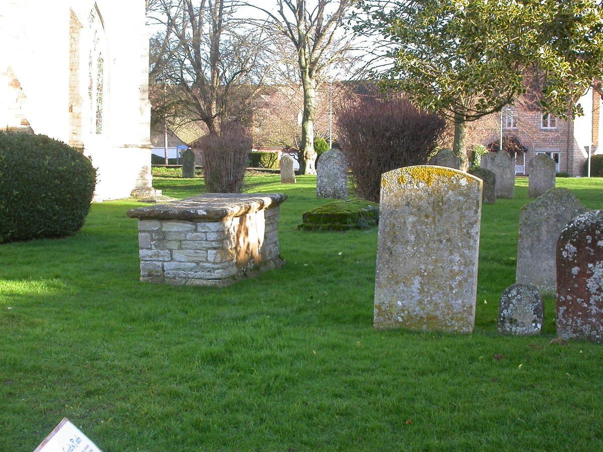 Behind and right of the chest tomb is a very mossy coped tomb. This is made of calcareous sandstone, more porous than most other stone in the graveyard and the moisture holding properties gives moss an advantage.