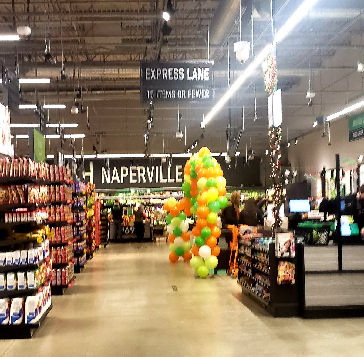 When using the Amazon Dash Cart experience, you exit through this lane, denoted by the balloons for the opening. A clerk was there to help acclimate shoppers to the experience. This is also the moment you would scan any coupons.