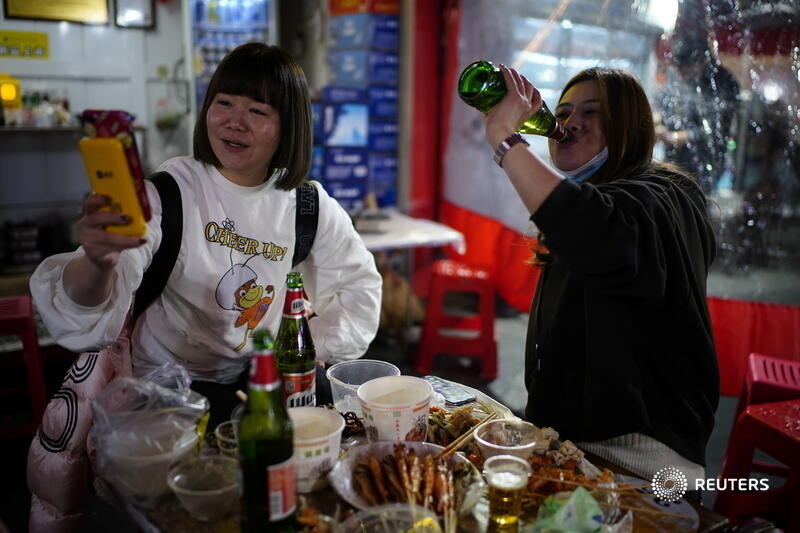 In scenes unimaginable in many cities around the world reeling under a resurgence of the pandemic, young Wuhan residents during a recent night out crowd-surfed, ate street food and packed the city's nightclubs as they looked to make up for lost time 4/6