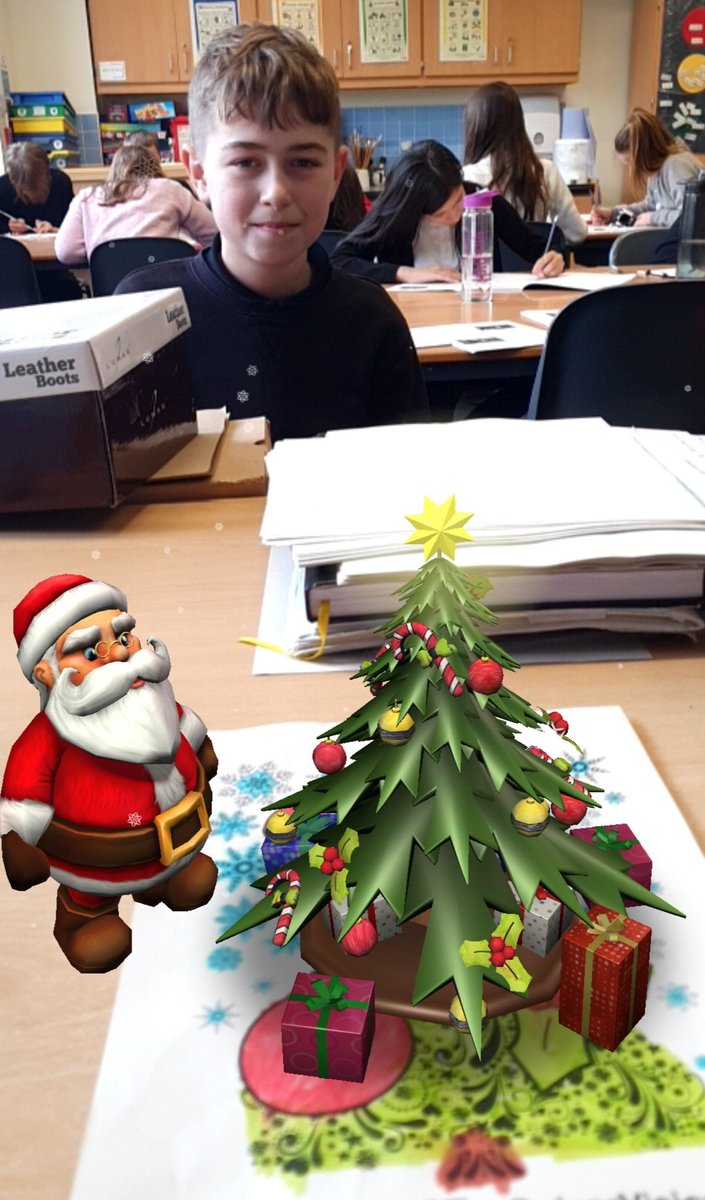 P6_7andMissG's tweet photo. Today we used @quivervision to turn our Christmas colouring into 3D virtual reality models! Great fun. Here  are K. and A. with their Christmas trees. A. is with her gingerbread house and the other one belongs to I.🎄☃️ https://t.co/mgsTZSbmEn