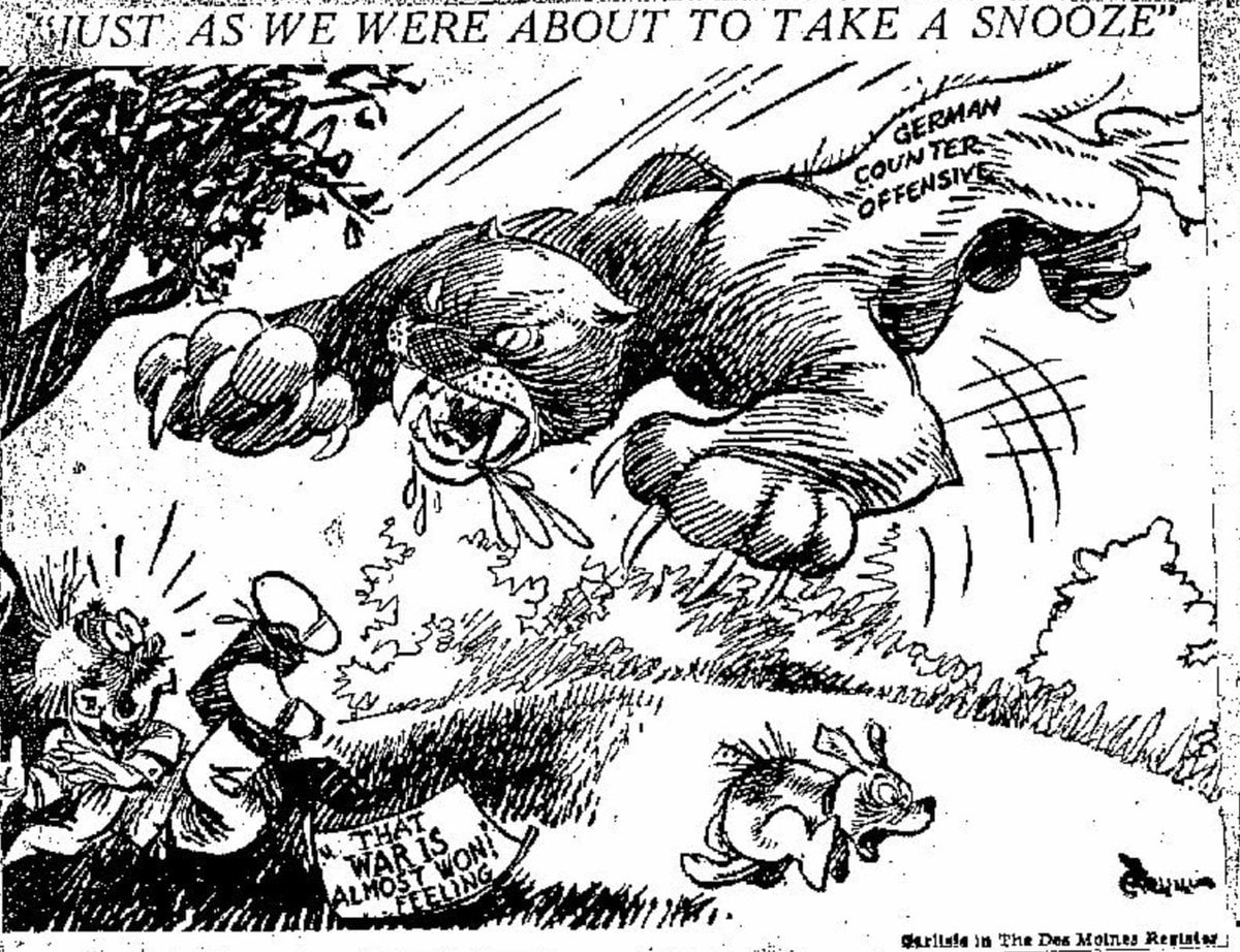 FINAL:This political cartoon published in the Des Moines Register on December 21, 1944, nails it. The Germans are depicted with an aggressive approach, ready to pounce, and the stunned Allies, about to take a nap, must scramble to get to their feet.