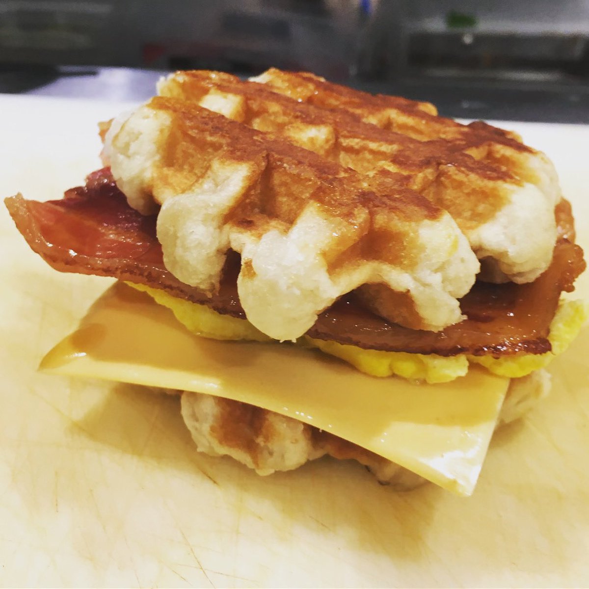 spokeskc's tweet photo. Guys, it’s really happening. Scrambled eggs, thin-cut bacon, american cheese and a drizzle of maple syrup between two slightly sweet liege waffles. Starting Sat 12/19. #spokeskc #wafflesandwich #waffles #dietstartsnewyearsday https://t.co/ZLHj08YFxA