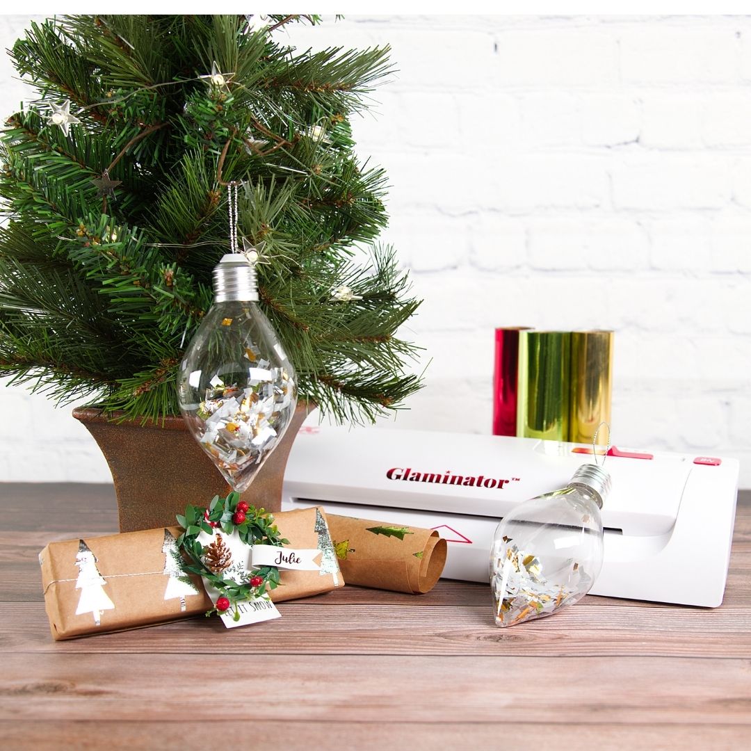 xyroninc's tweet image. The Xyron Glaminator is a fun craft tool to use, Make your own custom wrapping paper for those small gifts or a sparkly tag. Add shine to your tree by cutting some foil and adding it to a clear bulb. #craftwithxyron #xyronglaminator #foilingfun #xyronstickstogether #diy