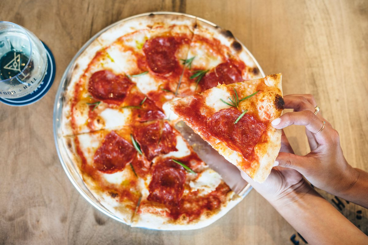 Slicing around the Christmas Tree, with a @ambrogio15sd pizza in our hands! 😆 Come get your favorite pizza to go! 🍕
