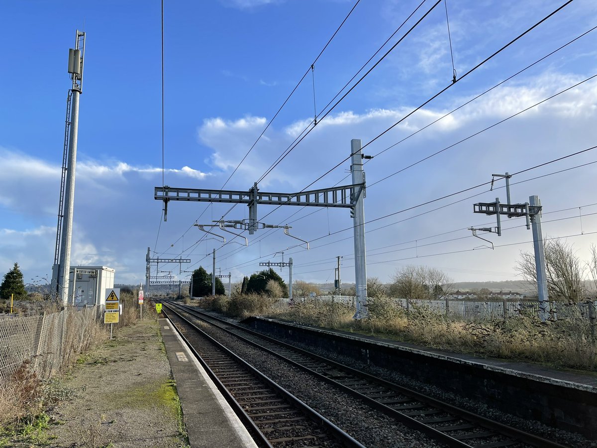 And on the inaccessible platform opposite stand Eric The Mast and Ernie The Mast, but which is which? (And does the gantry have a name too?) &ndash; bei  Pilning Railway Station (PIL)