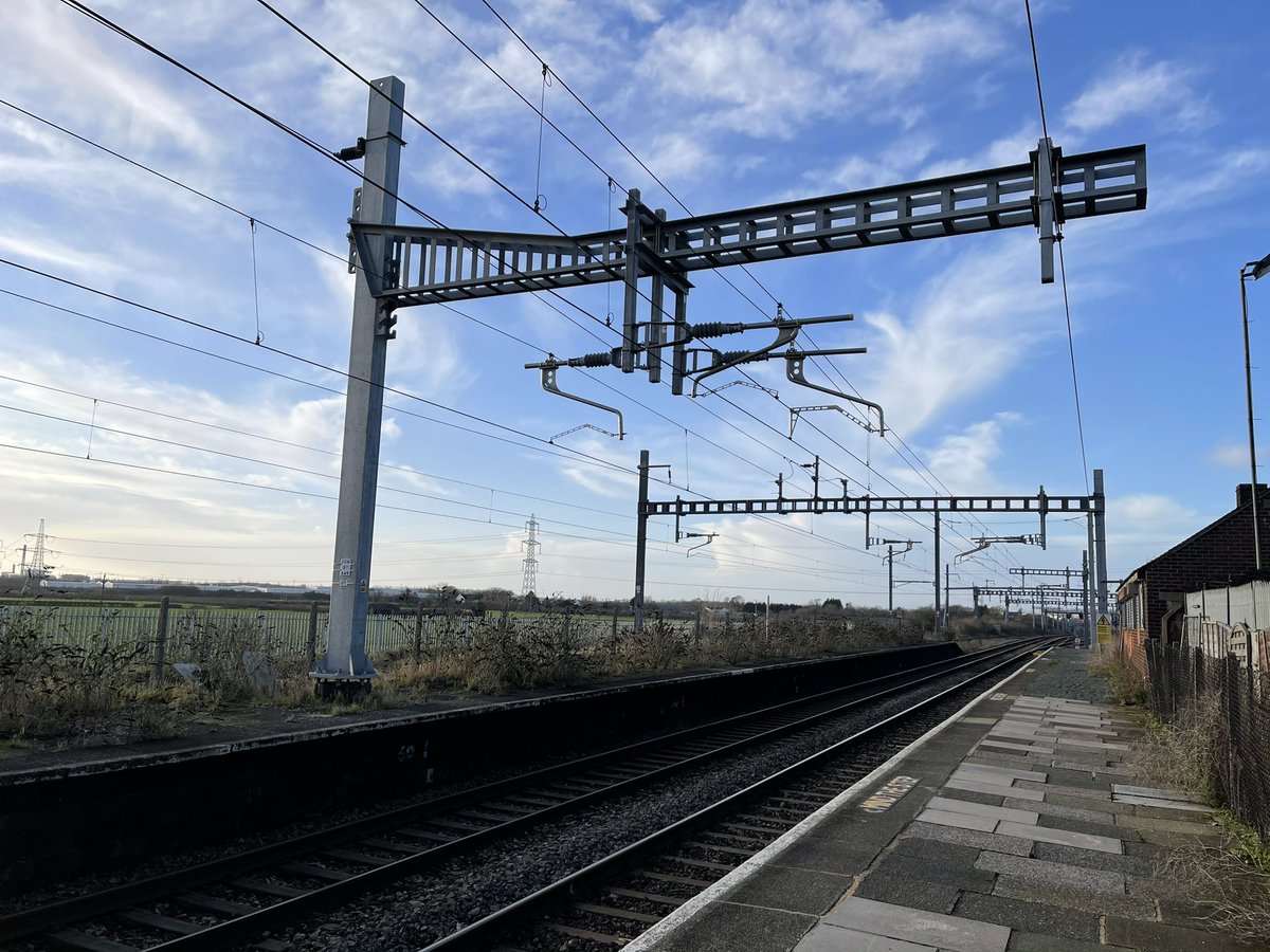 And on the inaccessible platform opposite stand Eric The Mast and Ernie The Mast, but which is which? (And does the gantry have a name too?) &ndash; bei  Pilning Railway Station (PIL)