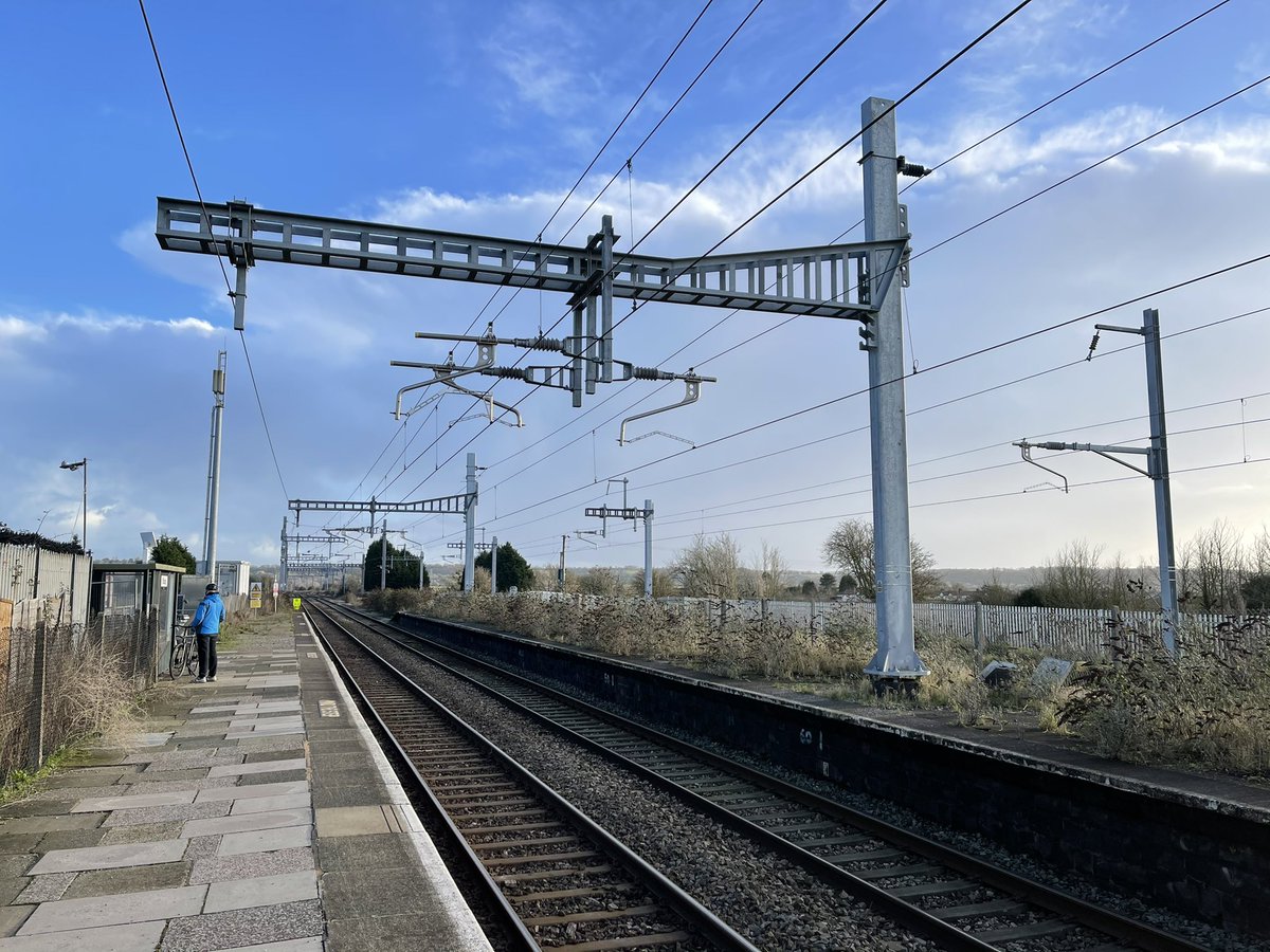 And on the inaccessible platform opposite stand Eric The Mast and Ernie The Mast, but which is which? (And does the gantry have a name too?) &ndash; bei  Pilning Railway Station (PIL)