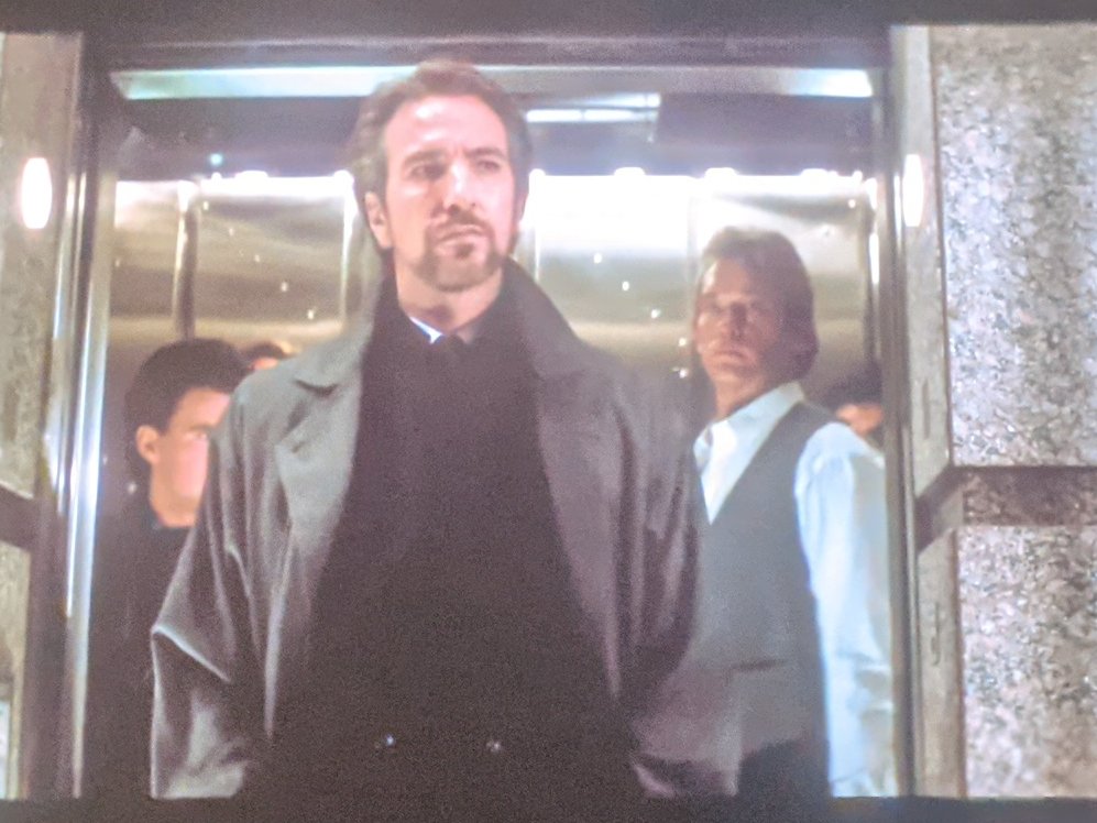 ALAN RICKMAN HAS ARRIVED.(With a guy who is not Huey Lewis, but damn. Damn does it look like him.)