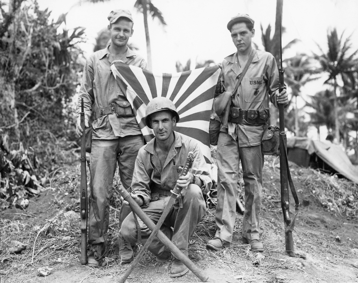 Marines and co with captured japanese weapons in the pacific