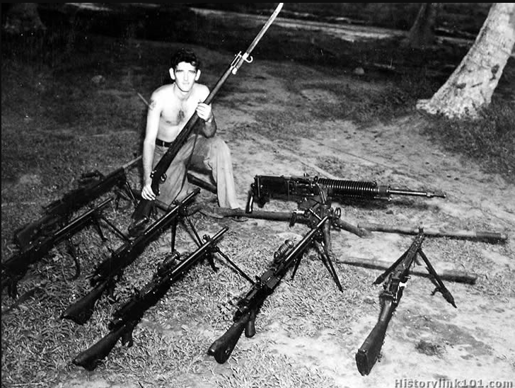 Marines and co with captured japanese weapons in the pacific