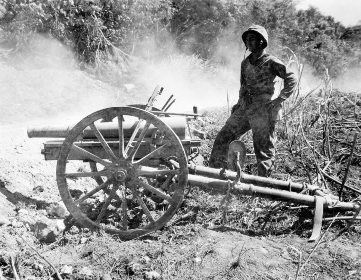 Marines and co with captured japanese weapons in the pacific