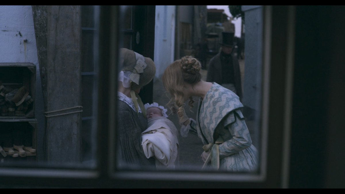 A love blossoms between two women in  #Ammonite. One sees the other through a window of a grocer. She observes how the younger woman smiles at the sight of a newborn baby. Is the window pane like the ideals of femininity that separate them? Thin yet terribly solid like glass?