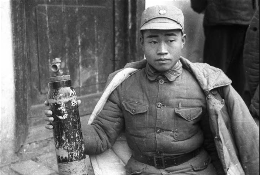 Chinese soldier with a Japanese chemical weapons canister in Hunan province, 1943