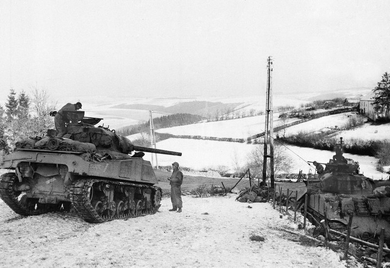 9 of 12:The armor elements picked up by the 101st get into the fight early on the morning of December 20, engaging German tanks. [pic: American tanks wait for German tanks on the slopes outside Bastogne]
