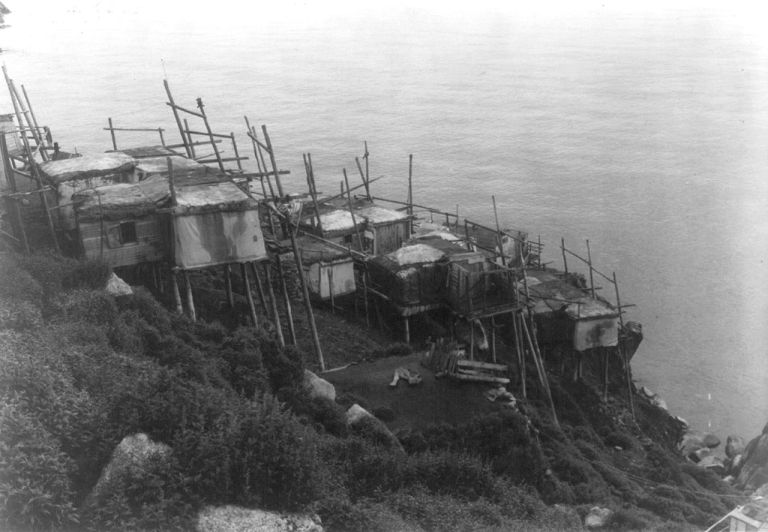 12. One of the oldest types of houses still widely used all over the planet—and a frequent setting in my intimate spatial reveries—is the adaptive stilt architecture.Here's the abandoned village of Ukivok on King Island in the Bering Sea, west of Alaska (photos 1892 and 1978)