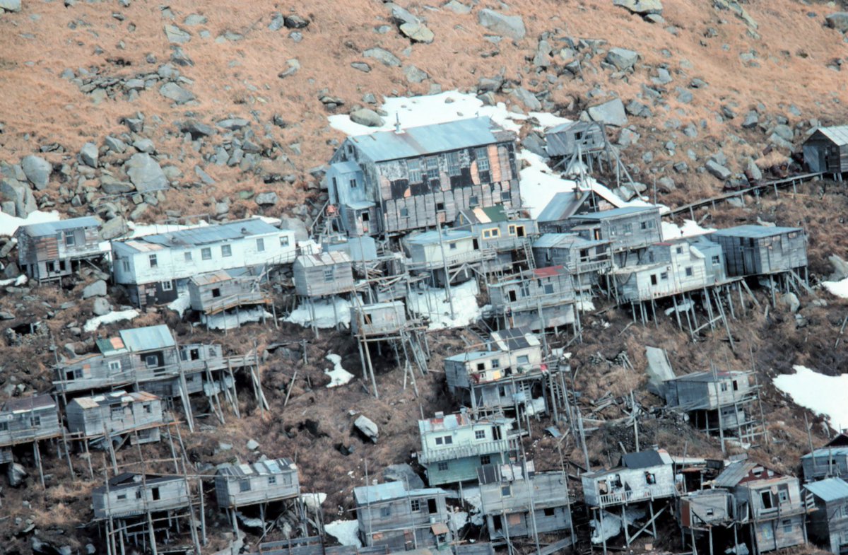 12. One of the oldest types of houses still widely used all over the planet—and a frequent setting in my intimate spatial reveries—is the adaptive stilt architecture.Here's the abandoned village of Ukivok on King Island in the Bering Sea, west of Alaska (photos 1892 and 1978)